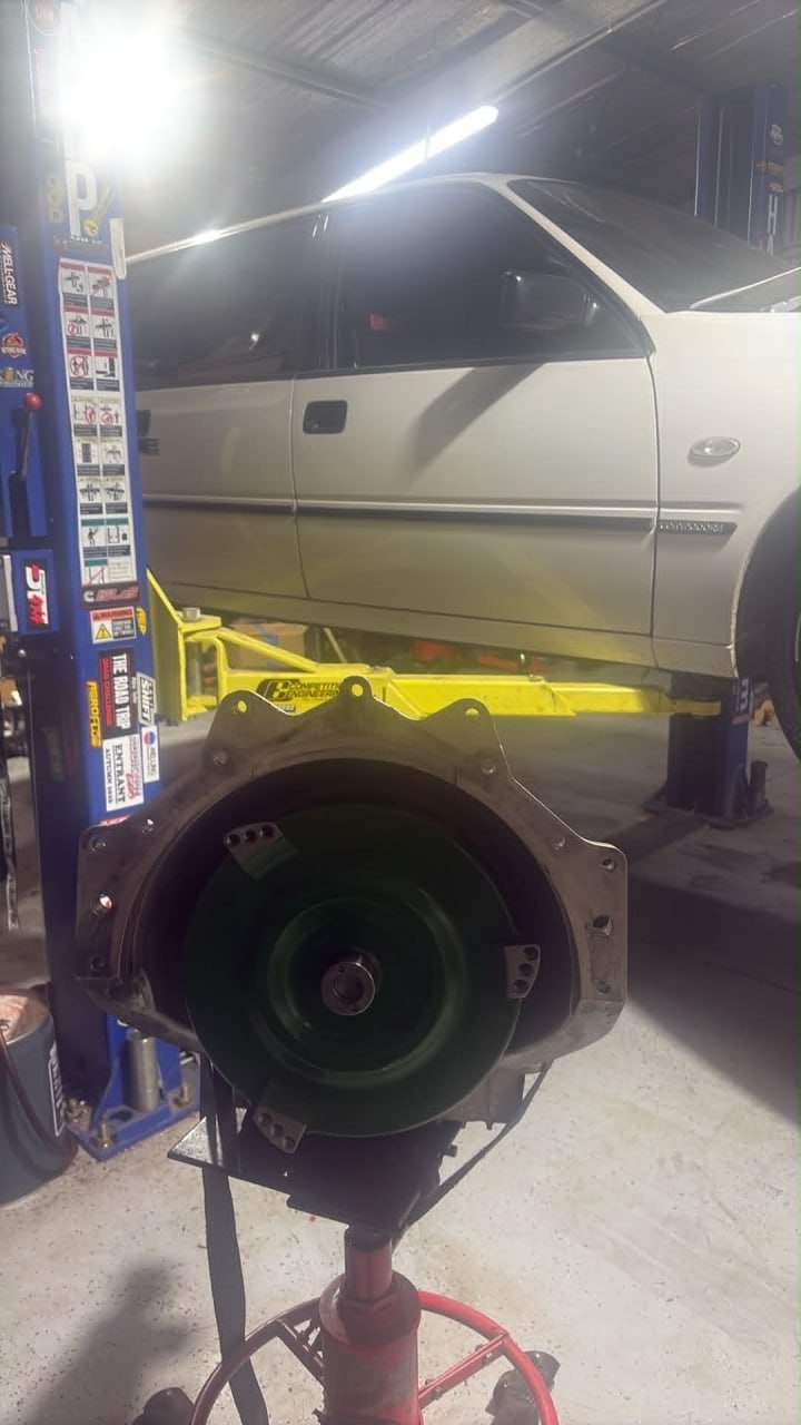 Transmission on workshop jack under a lifted vehicle